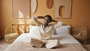 Adult stretching on the edge of the bed with body aches without fever