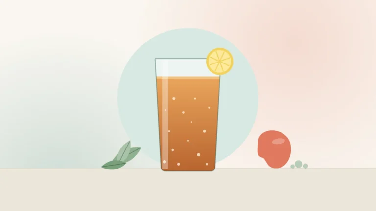 Illustration of a glass of kombucha with a lemon slice, tea leaves and a kidney shape